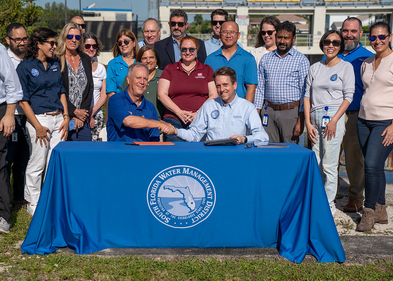 Broward Commissioner Beam Furr shakes hands with South Florida Water Management District Executive Director Drew Bartlett after signing the Final Integrated Feasibility Report and Environmental Assessment for the Central and Southern Florida Flood Resiliency (Section 203) Study
