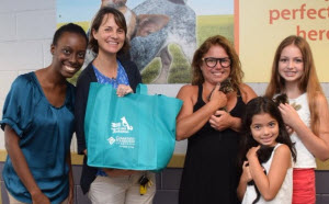 Broward County Animal Care Foster Coordinators Krystal Mapp and Carrie Gipson (far left) join Foster Parents Victoria Mejia and her daughters.  