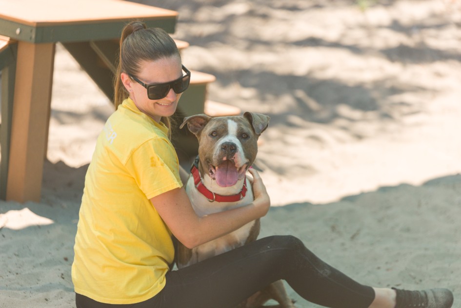 Woman holding dog.